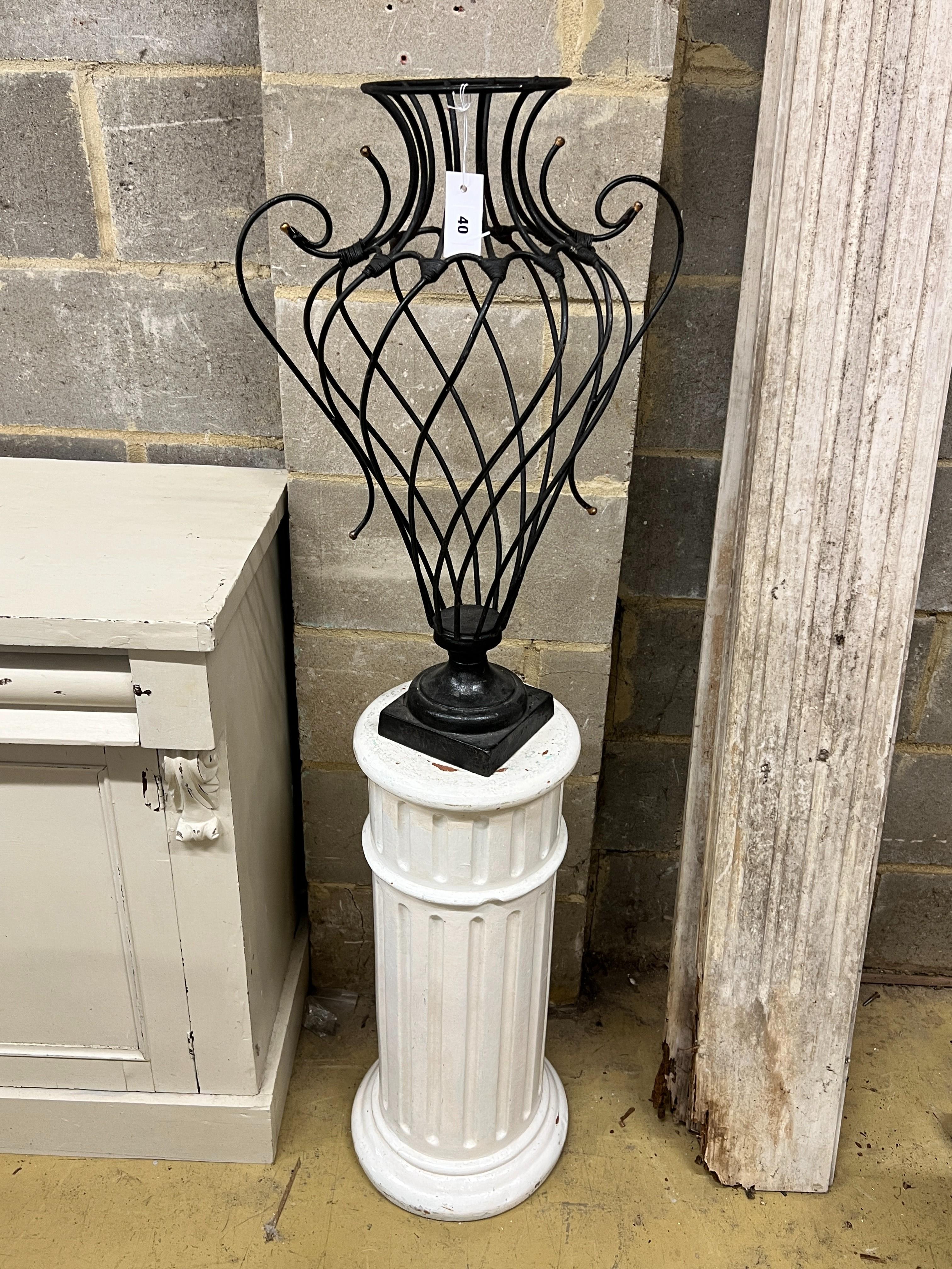 A painted wrought iron vase shaped ornament on painted fluted pedestal, total height 139cm